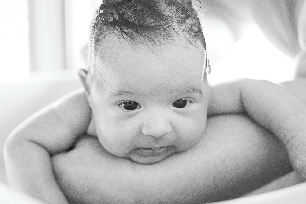 Black-and-white portrait of Anya during a bath, looking at the camera. Águas Santas, Portugal. 2025 © Pedro Rodrigues